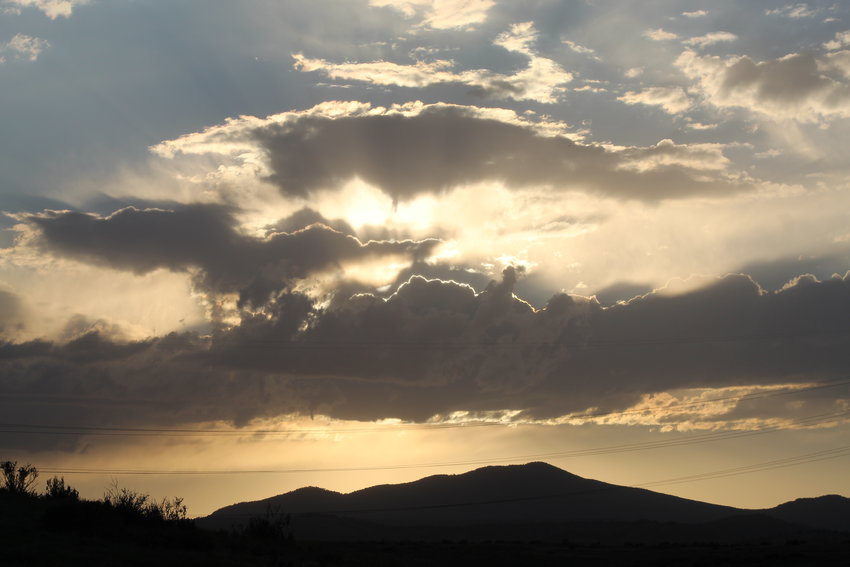The sun sets over the foothills west of South Table Mountain on June 16.